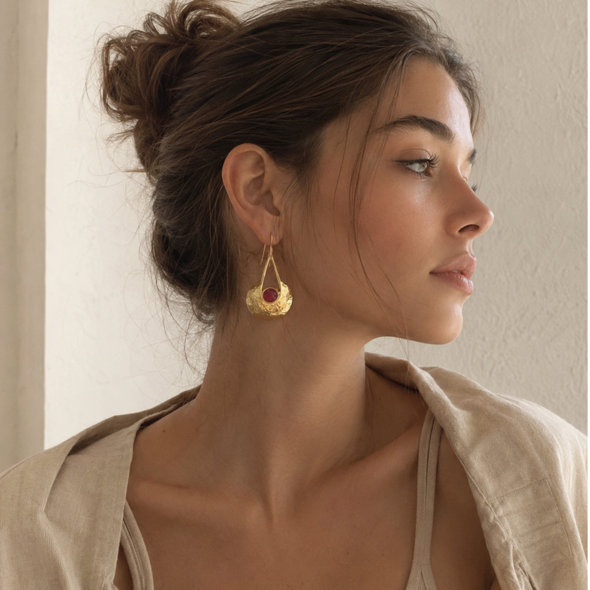 Elif Gold Disc Ruby Dangle Earrings worn by a woman with a gold disc and ruby drop