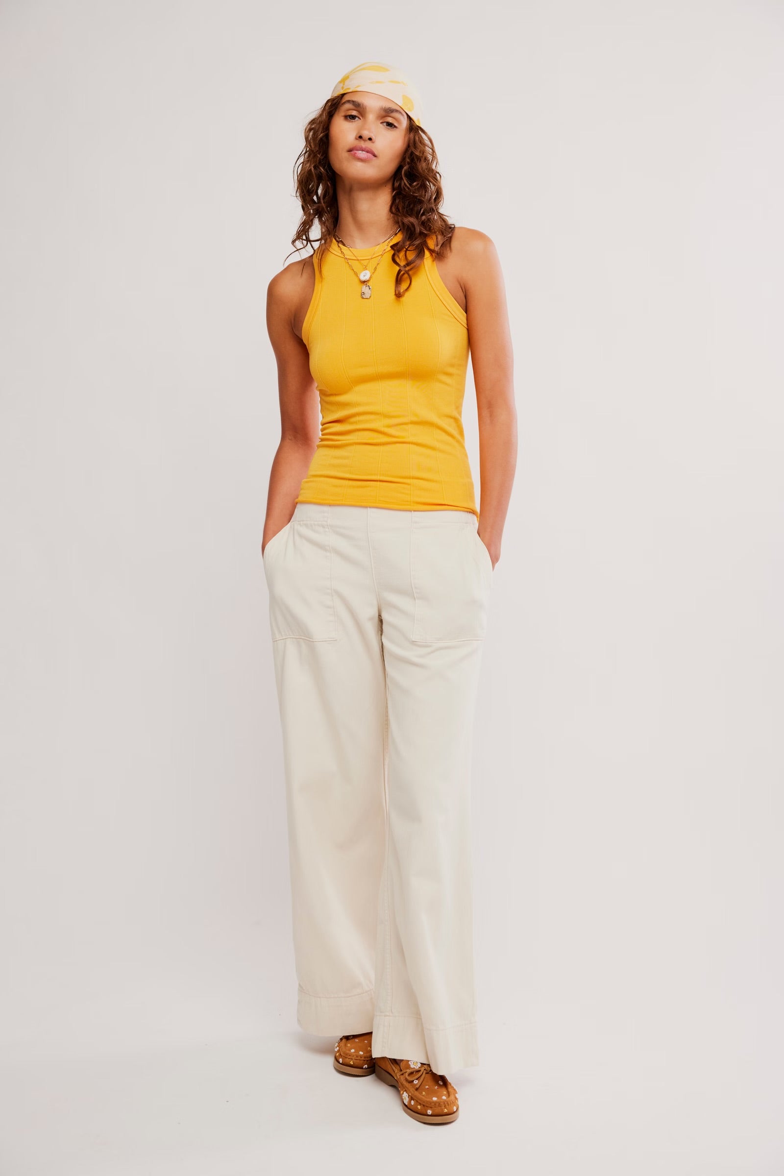 Model wearing a yellow sleeveless top styled casually in the So Soft Seamless Modal Tee in Destiny.