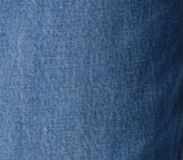 Close-up of soft blue denim fabric texture featuring REN JEAN in chapter for versatile everyday styling