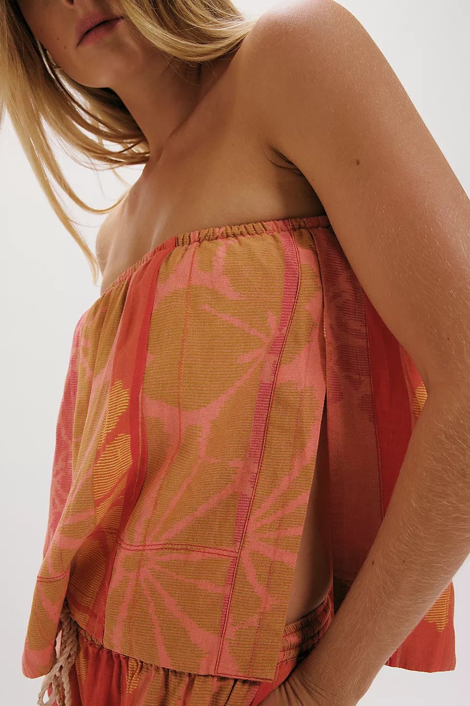 Close-up of woman wearing strapless color-block top with floral patterns from FREE PEOPLE DEVELLA SET