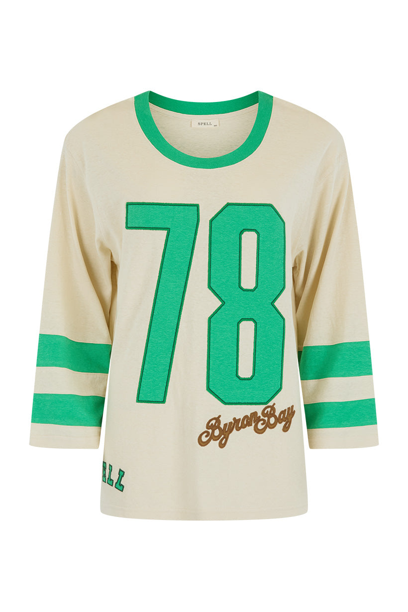 Homecoming Long Sleeve Biker Tee with green number 78 details and striped sleeves on a cream background