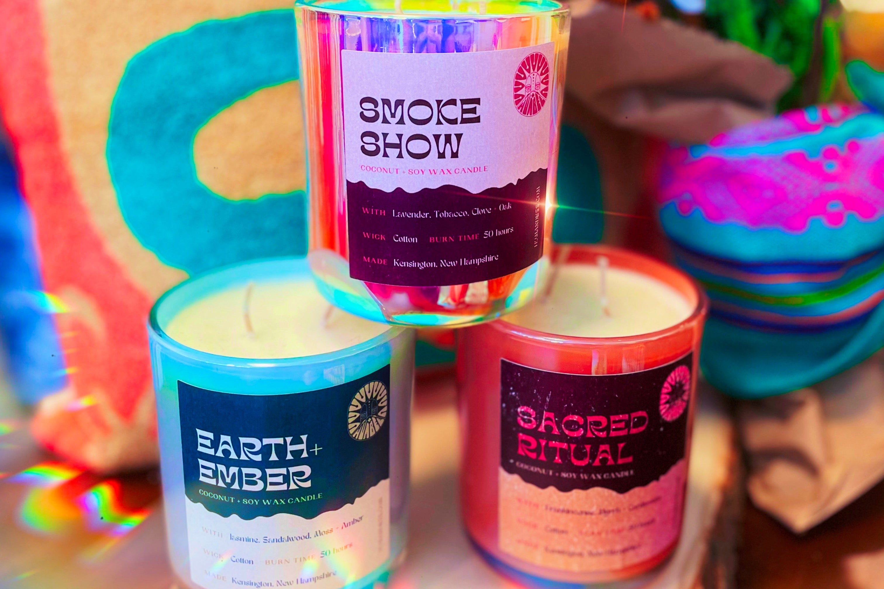 Three candles with colorful labels on a decorative background