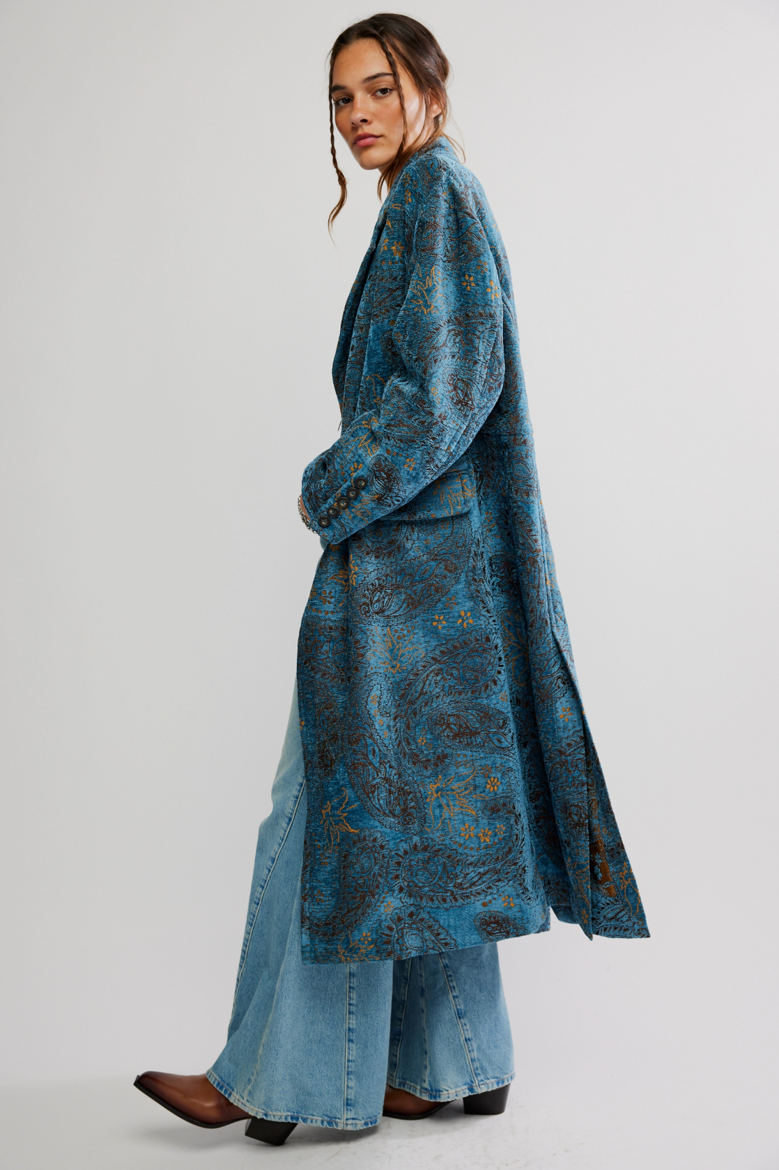 Wearing the Micha Duster by Free People, this woman embraces effortless elegance in a blue longline coat.