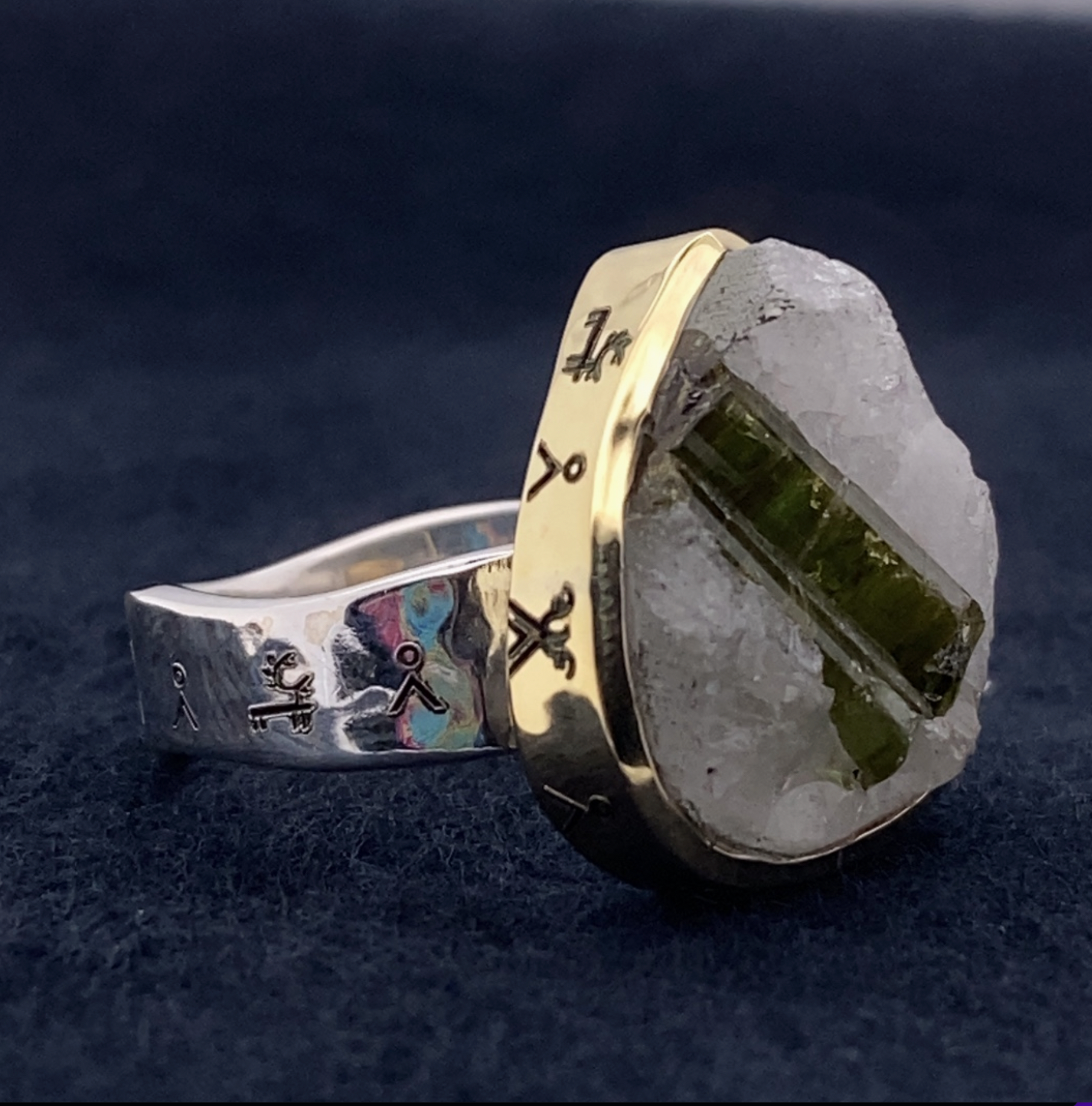Ring with gold and silver design on a dark blue background