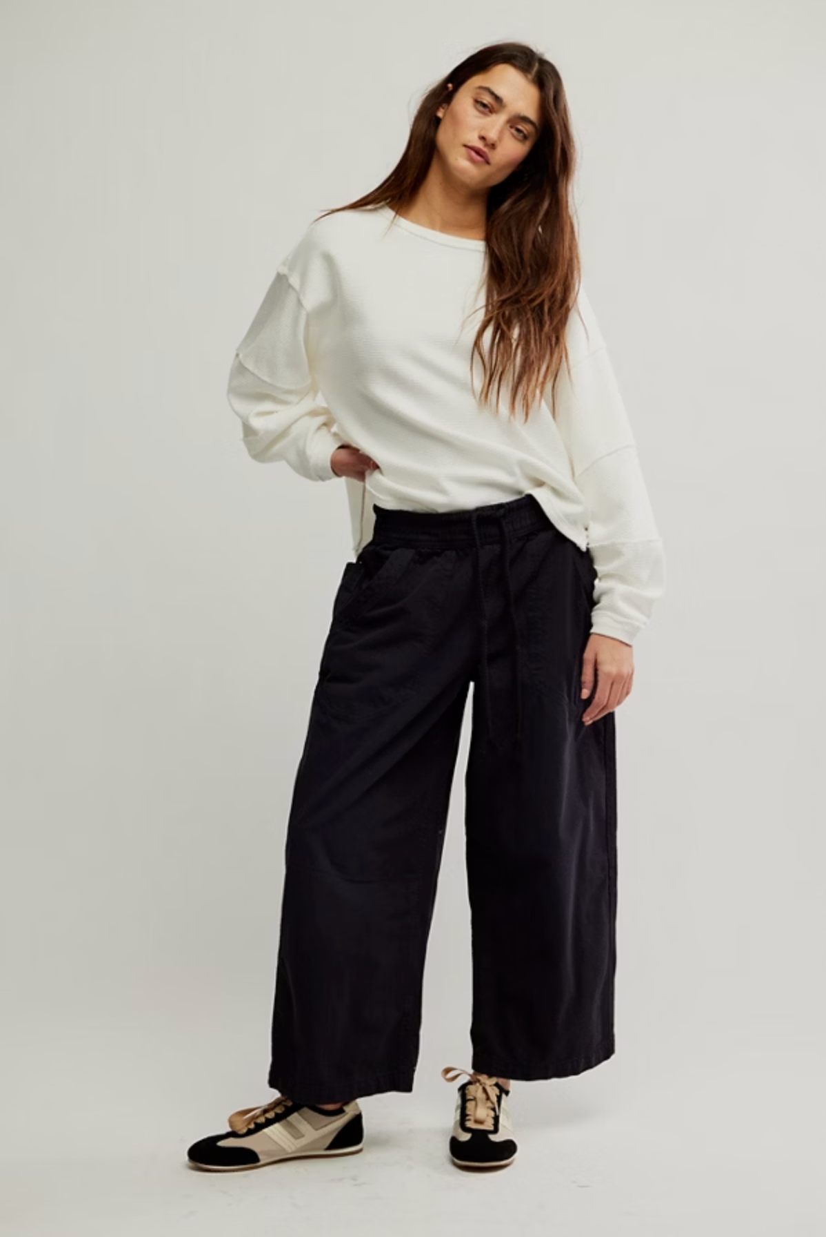 Woman wearing relaxed black pants and white sweatshirt styled with We The Free Easy Peasy Pull-On Jeans showcasing casual comfort and style