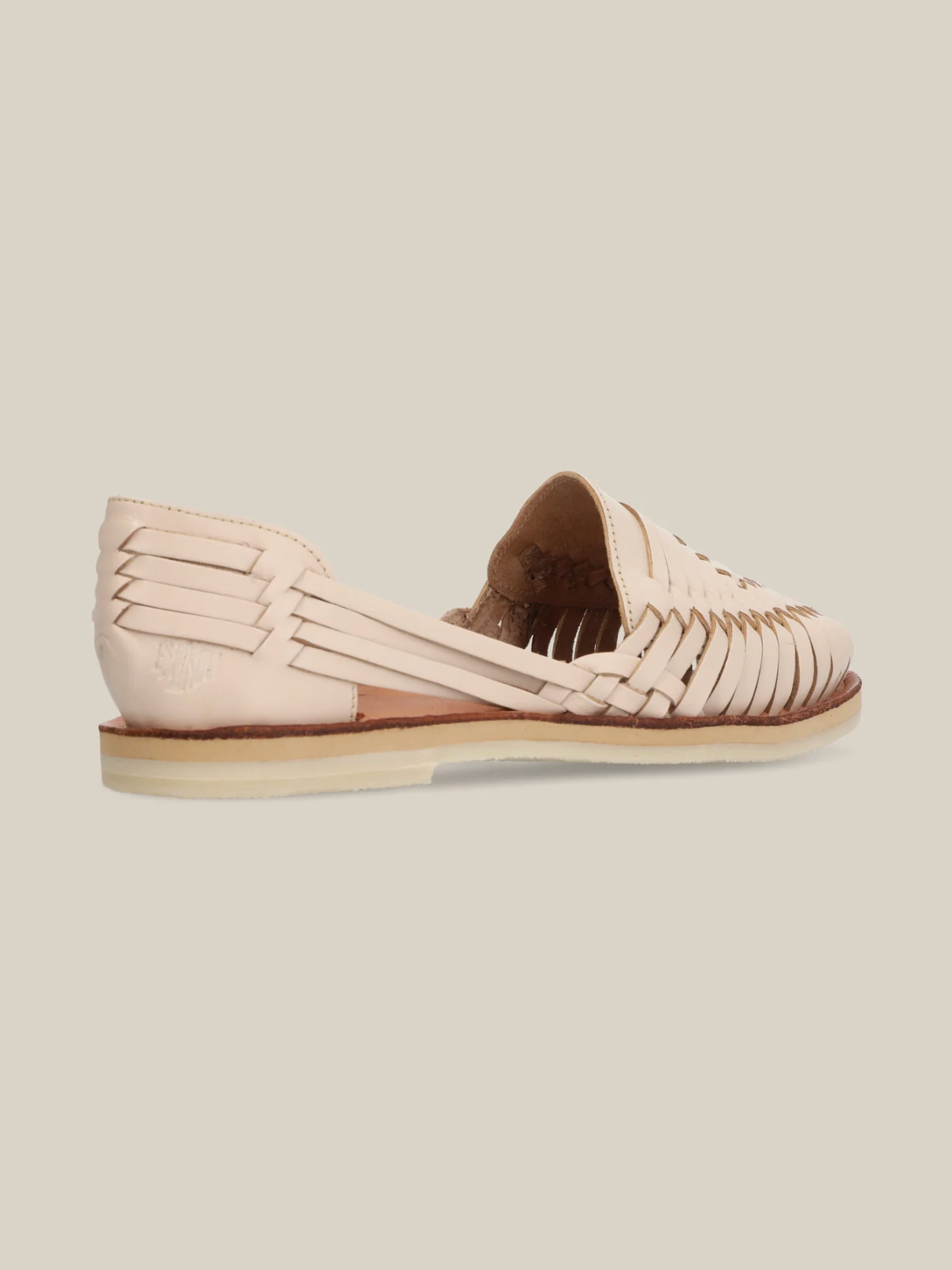 Side view of a light tan woven leather sandal showcasing Desierto Classic Huaraches with a flat sole and intricate artisan design