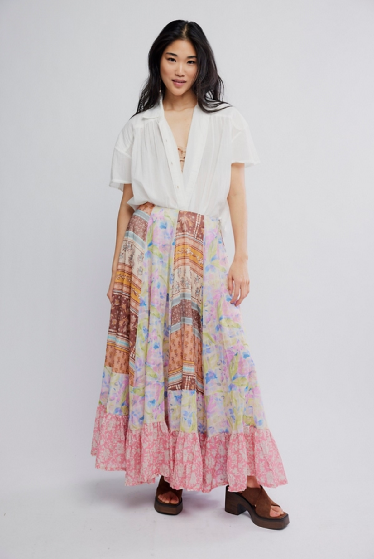 Woman wearing Santa Eulalia Printed Maxi Skirt by Free People with a white blouse and platform sandals.