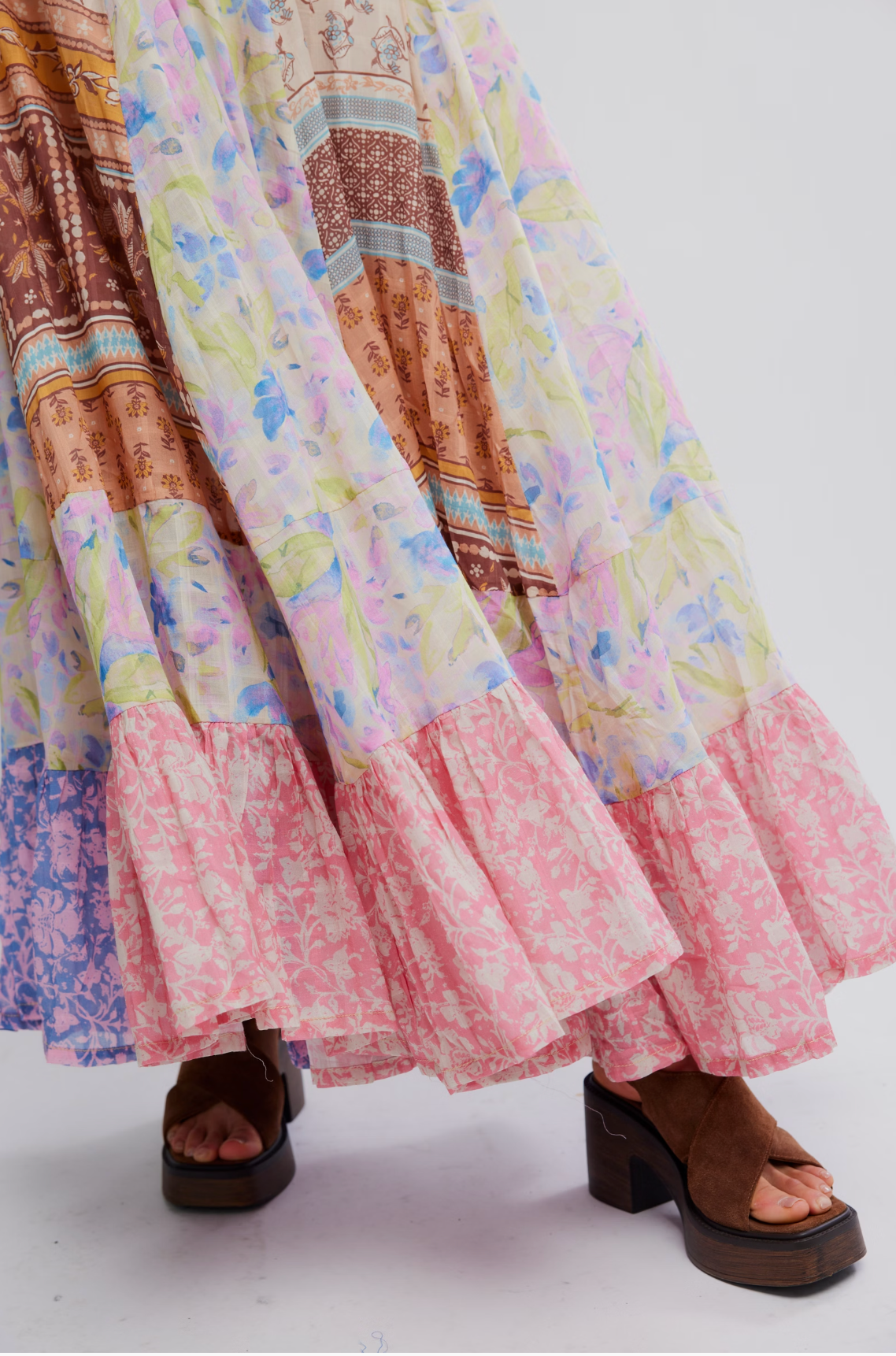 Flowing colorful fabric detail of Santa Eulalia Printed Maxi Skirt by Free People with brown platform sandals