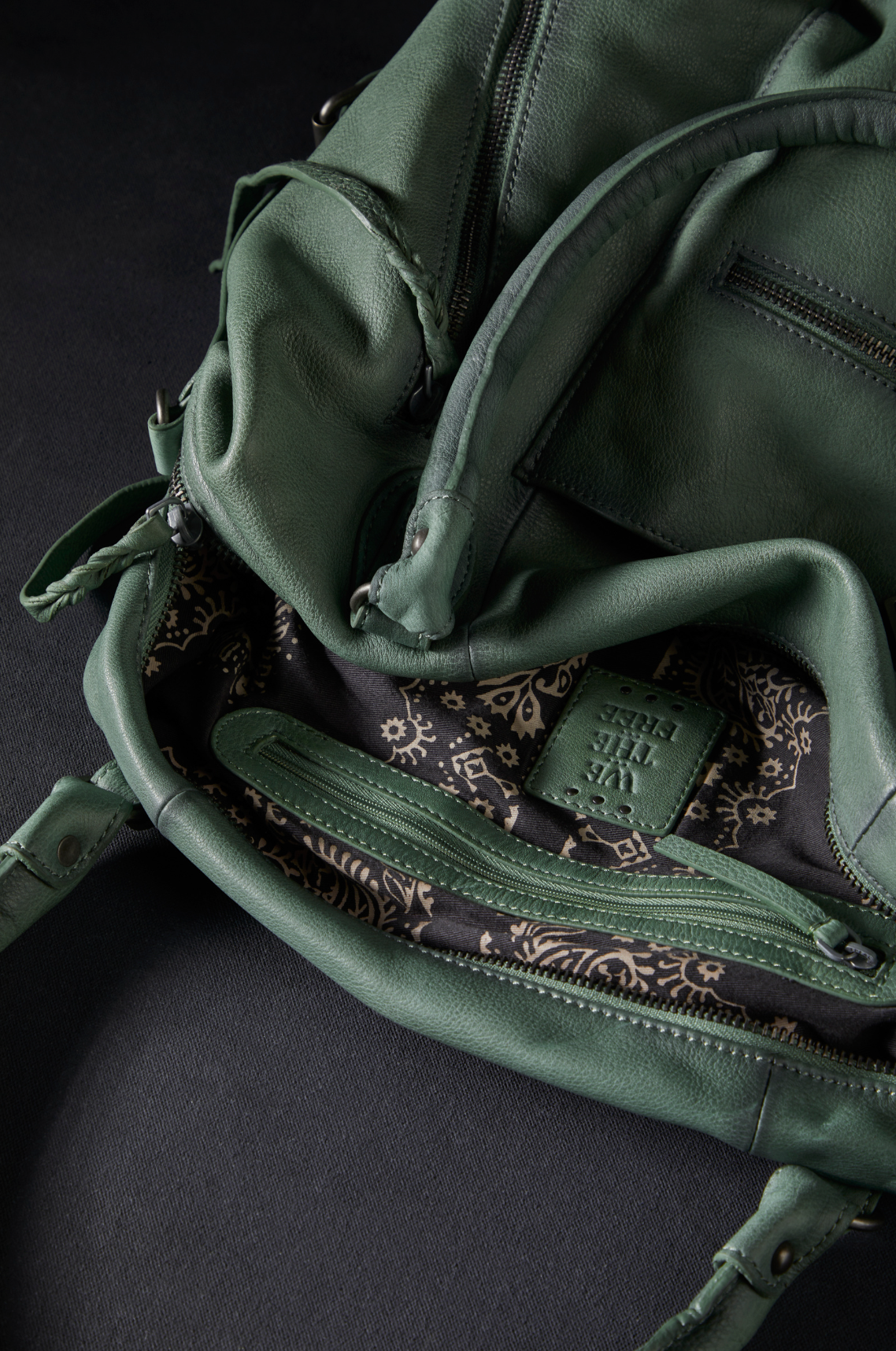 We The Free Emerson Tote Bag in Secret Sage showing soft leather with patterned interior and zipper pocket detail.