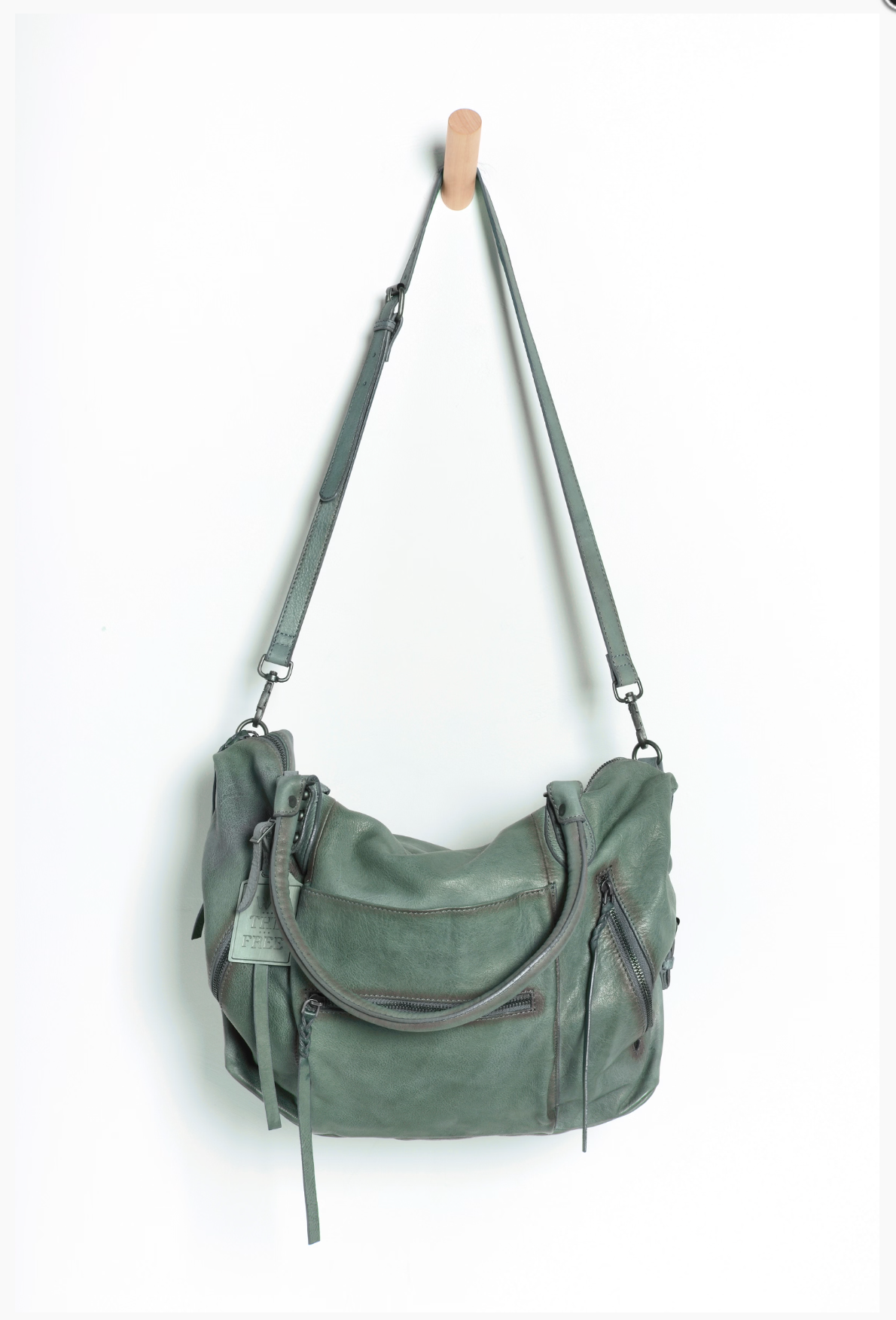 We The Free Emerson Tote Bag in Secret Sage hanging with adjustable shoulder strap and zippered compartments