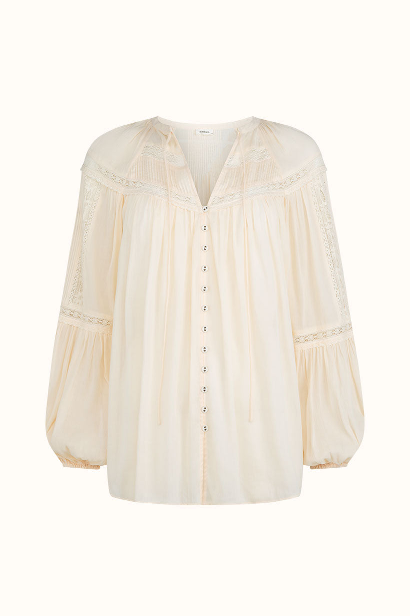 The Teodora Blouse - White Smoke by Spell is a long-sleeve top made from soft LENZING ECOVERO Viscose, featuring lace details, gathered cuffs, a loose fit, button-down front, and a subtle v-neck with ties.