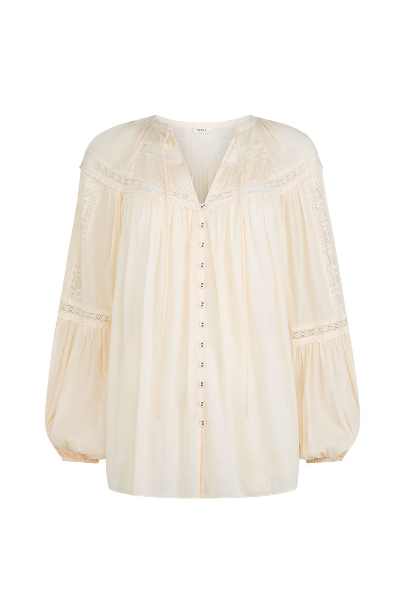 The Teodora Blouse - White Smoke by Spell features lace-trimmed shoulders and sleeves, a V-neck with tie strings, front button closure, and is crafted from sheer LENZING ECOVERO Viscose for an airy feel.