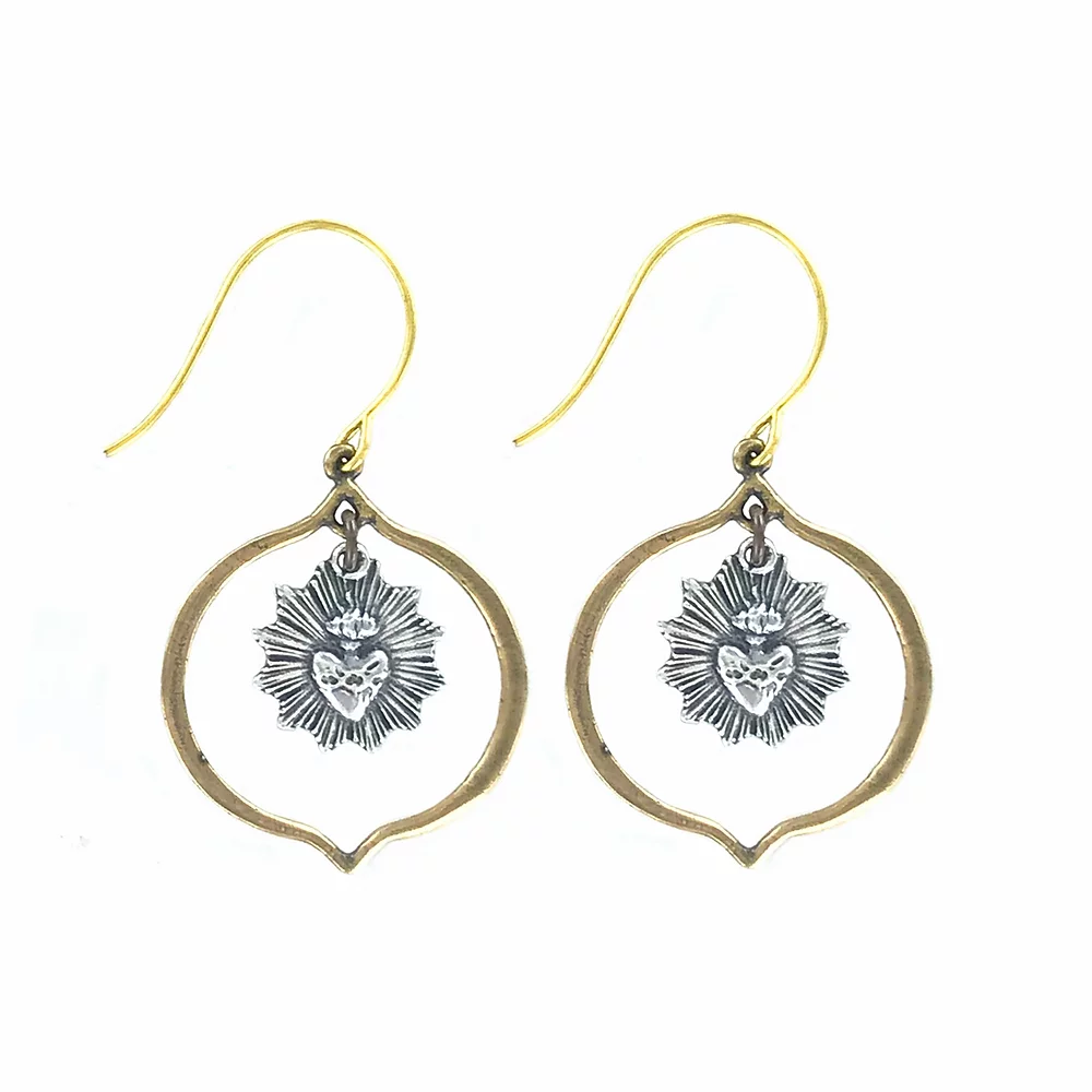 The Sacre Couer Small Earrings by Tara Gasparian Jewelry feature gold hooks, open teardrop frames, and silver sunburst charms with heart and skull details—adding a unique touch to your style.