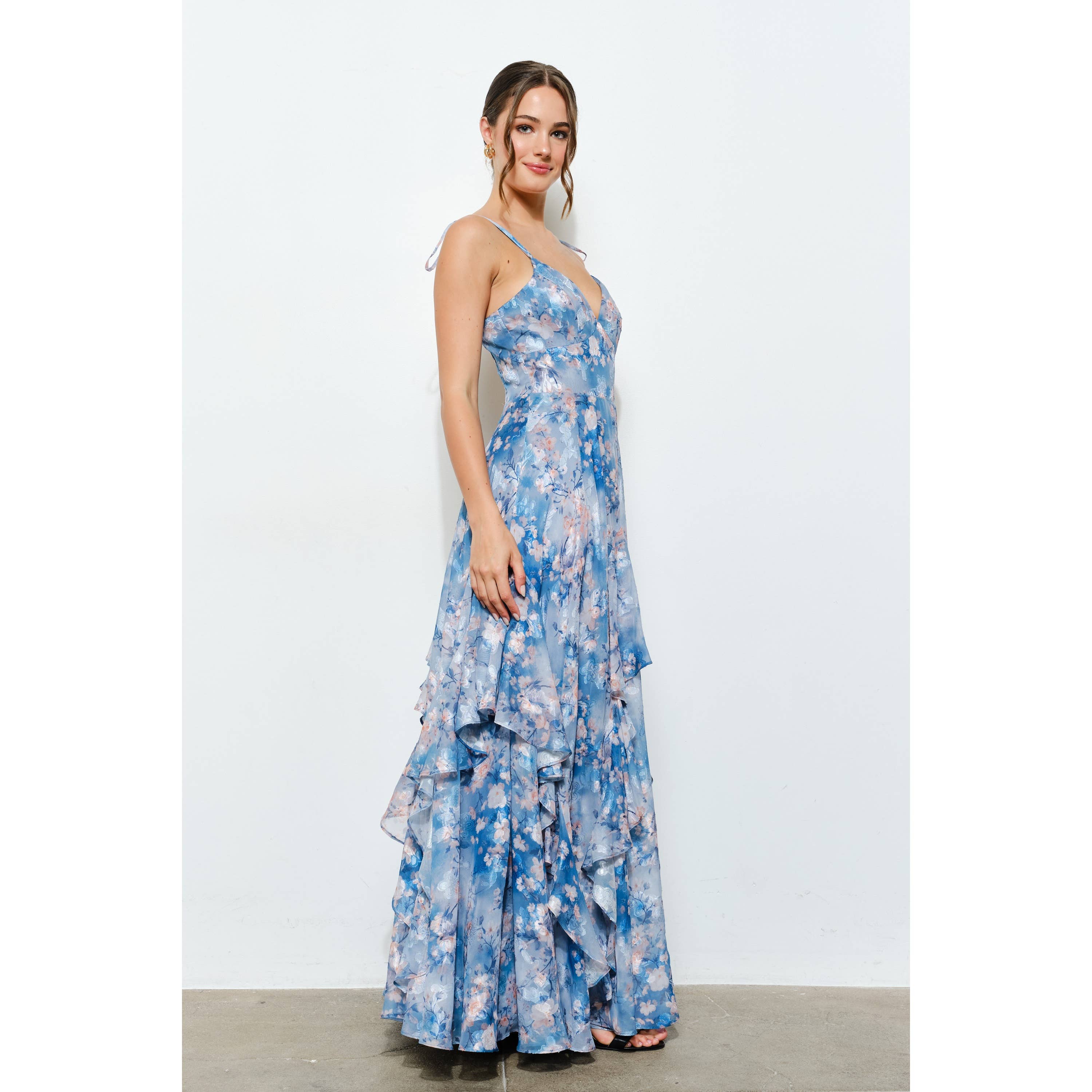 Model wearing a flowing blue floral Romantic Floral Sweetheart Ruffled Maxi Dress with ruffled layers and spaghetti straps