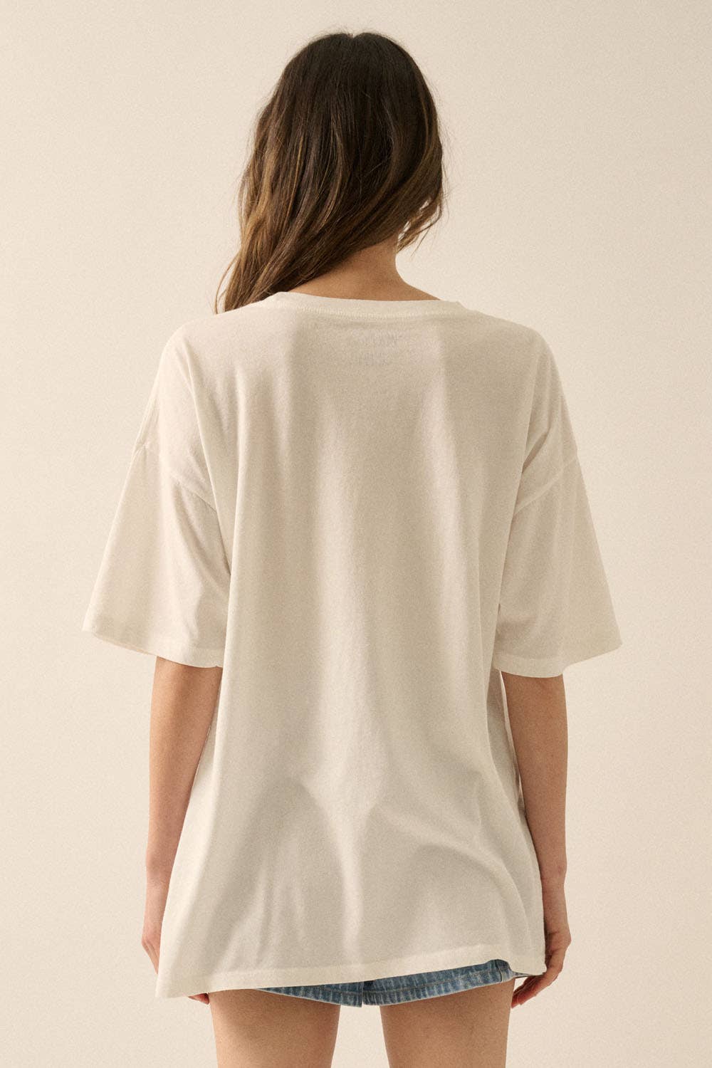 Woman wearing a relaxed fit Vintage Birds Garment Washed Oversized Graphic Tee in a soft light fabric from the back view
