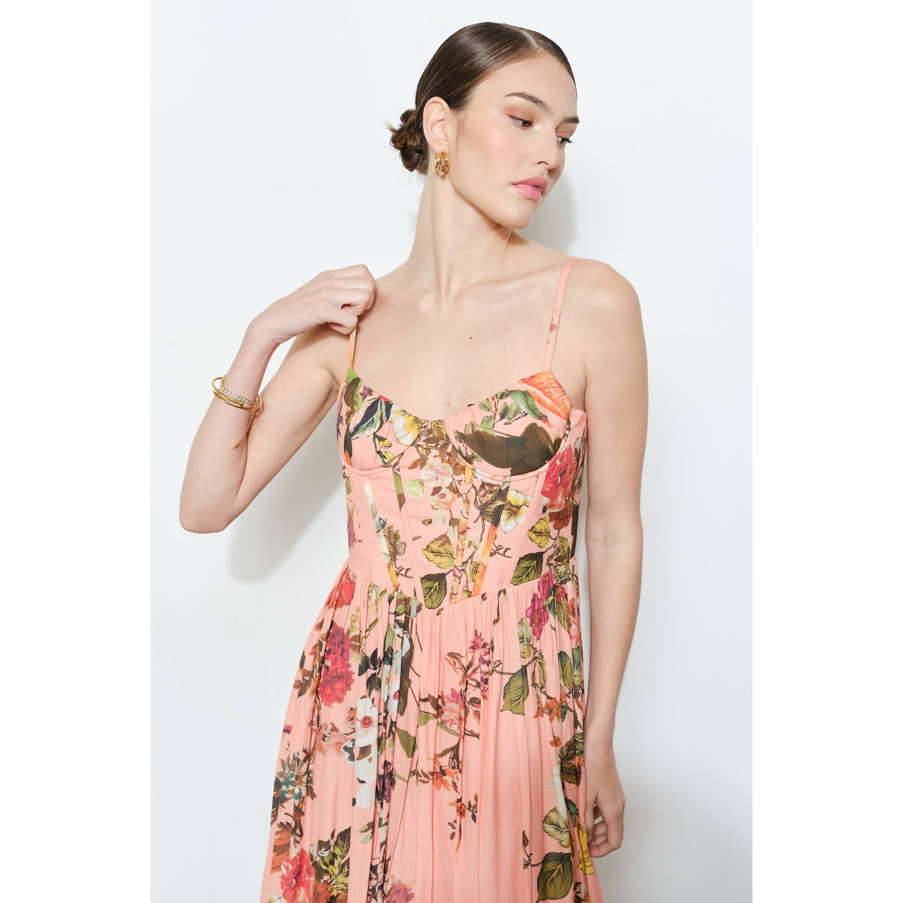 Woman wearing a Vintage Floral Sweetheart Maxi Dress with pink floral pattern and fitted bodice with thin straps