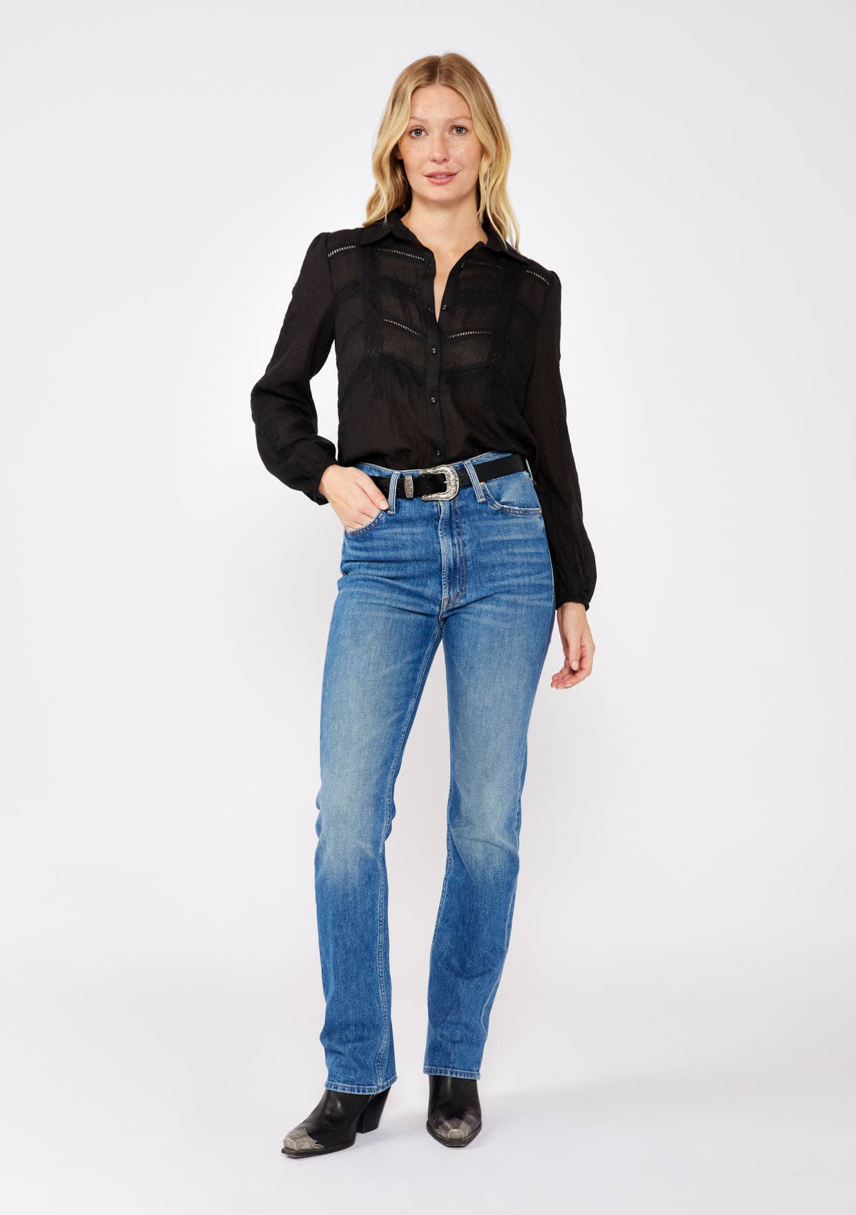 Woman wearing a black Crinkled Lace Long Sleeve Button Down Blouse paired with blue jeans and black boots.