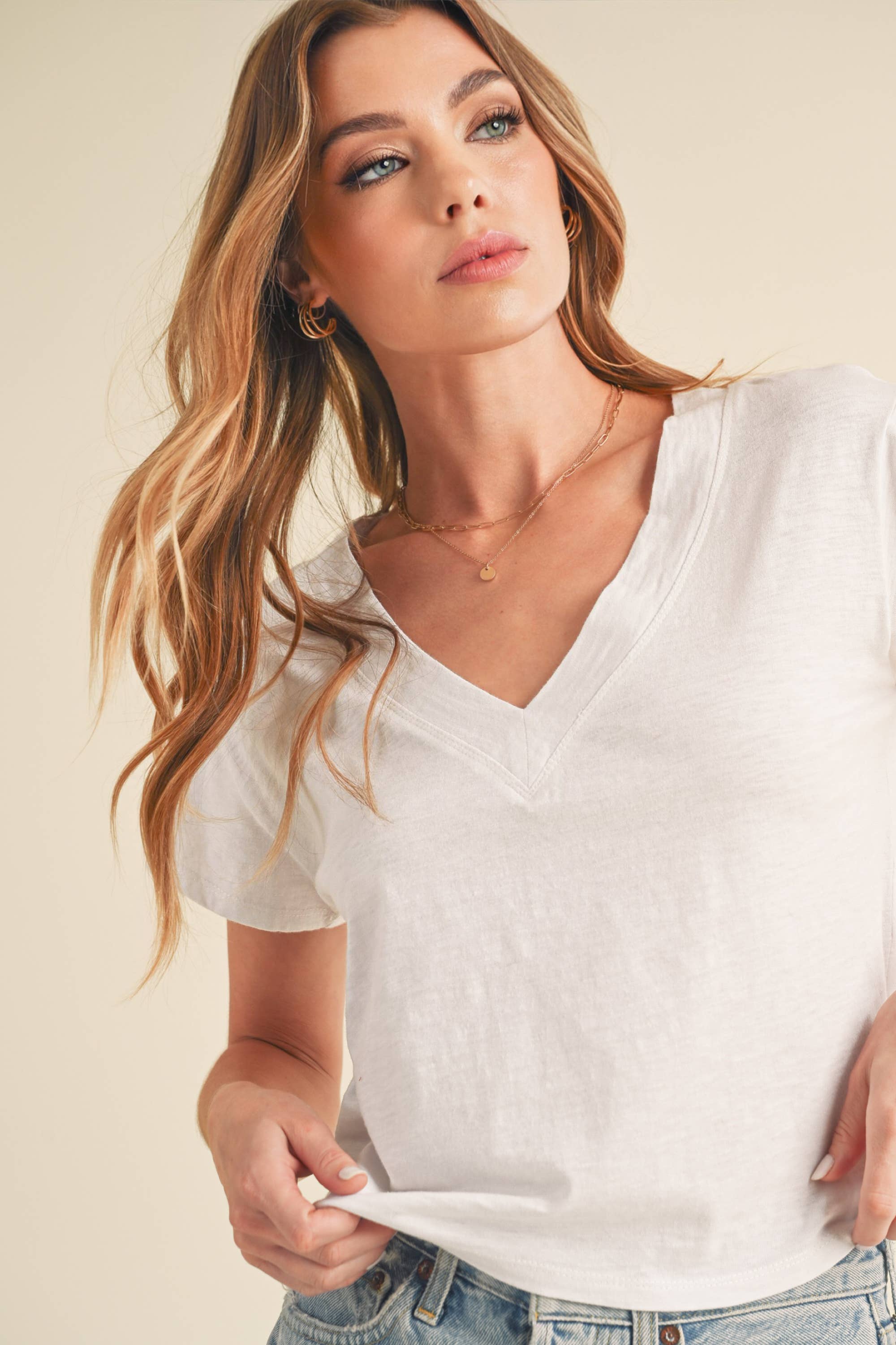 Woman wearing 8281DK Til V-Neck Baby Top: White / Contemporary / L with casual styling and lightweight fabric