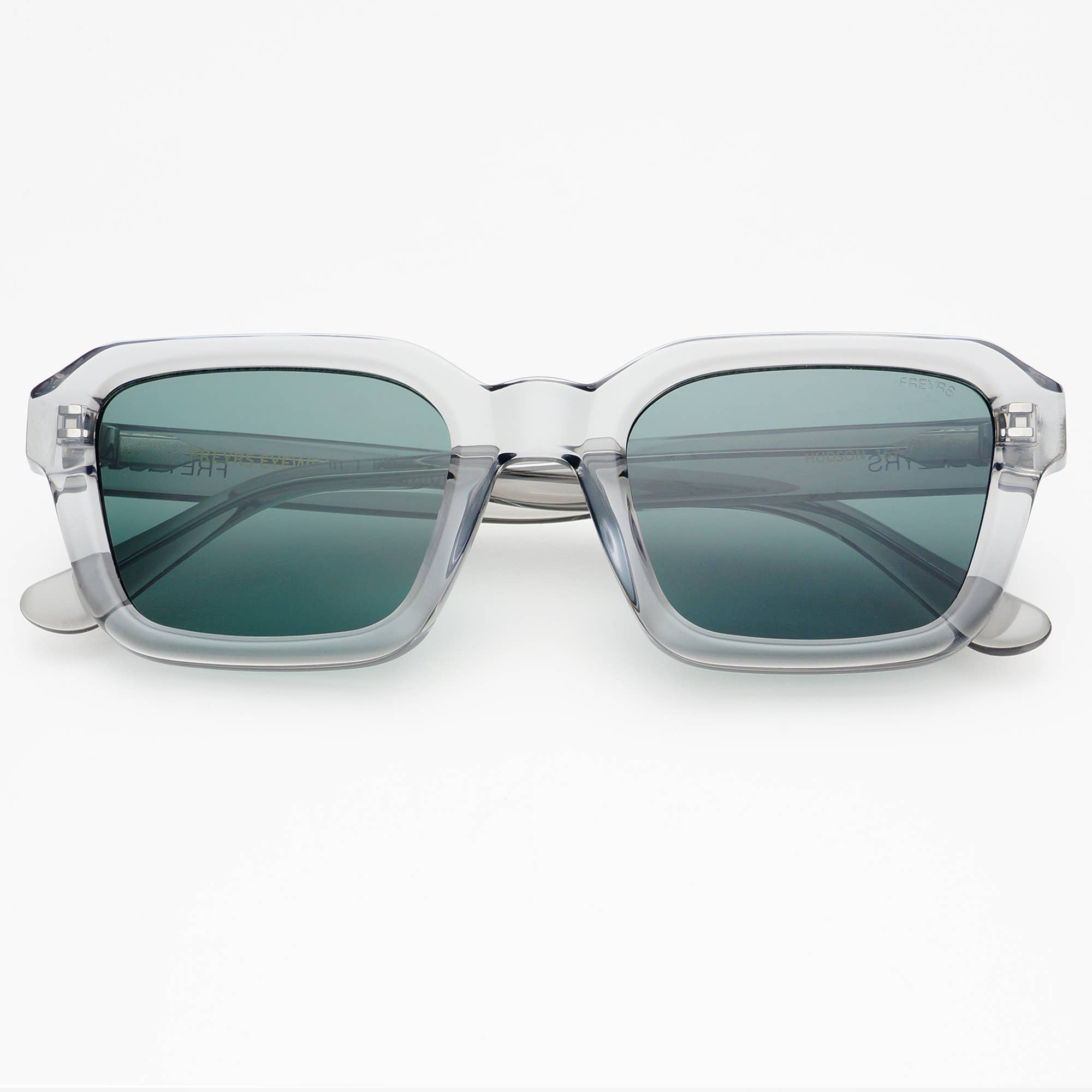 The Hudson Acetate Unisex Rectangular Sunglasses by FREYRS Eyewear feature clear handmade acetate frames and dark green CR39 lenses, shown facing forward on a white background.