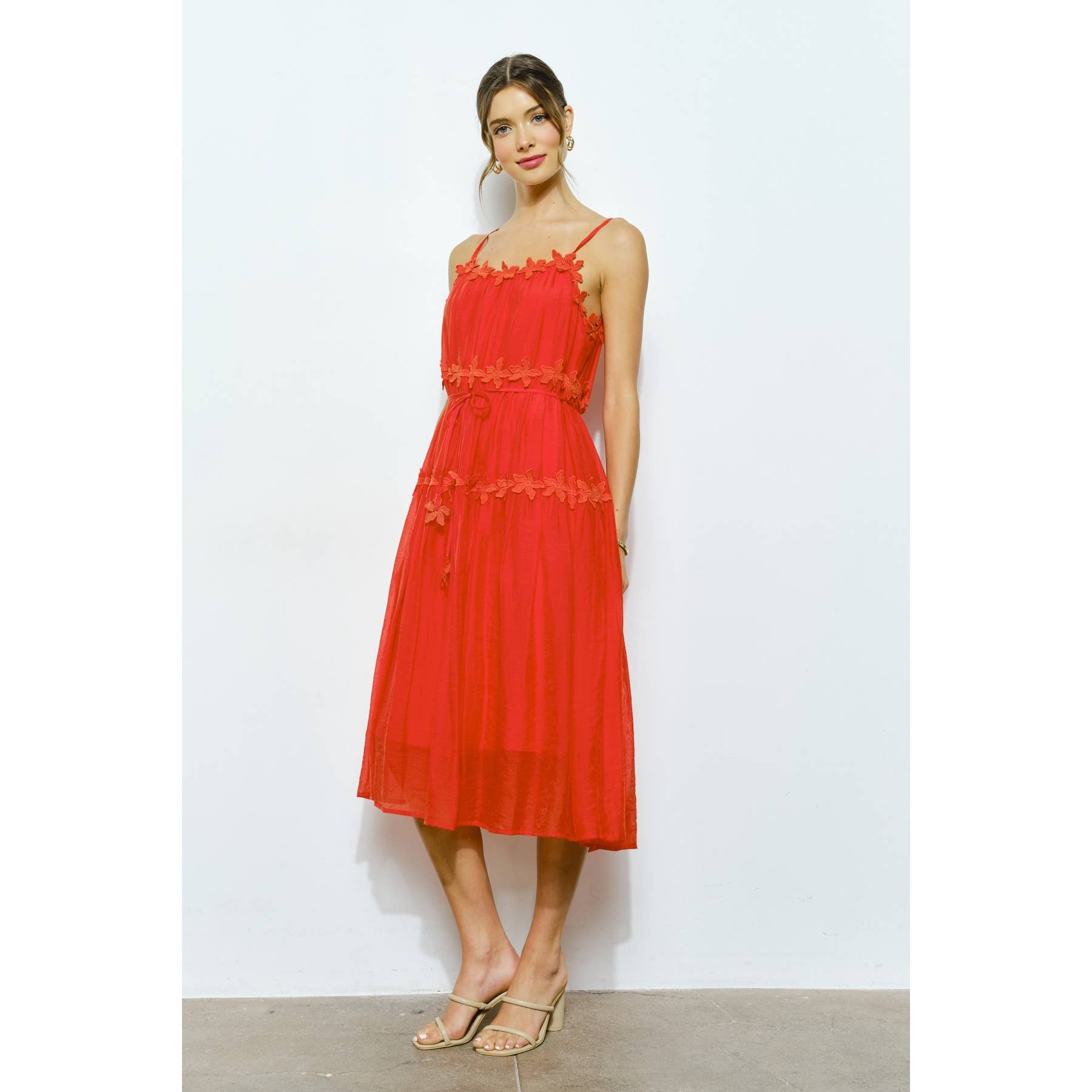 Woman wearing a red dress against a white background