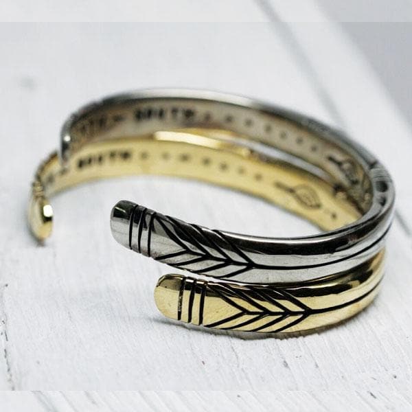 Medicine Wheel Cuff || Men in silver and gold tones with engraved arrow designs and artisan detailing on a white surface.
