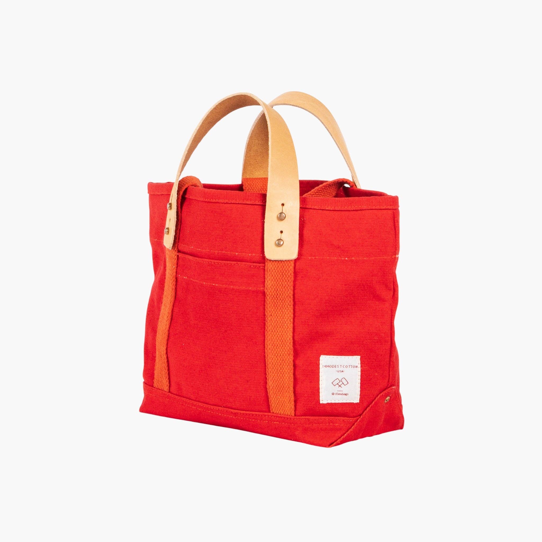 Lunch Tote | Persimmon canvas tote with natural leather handles and external pocket in vibrant persimmon color