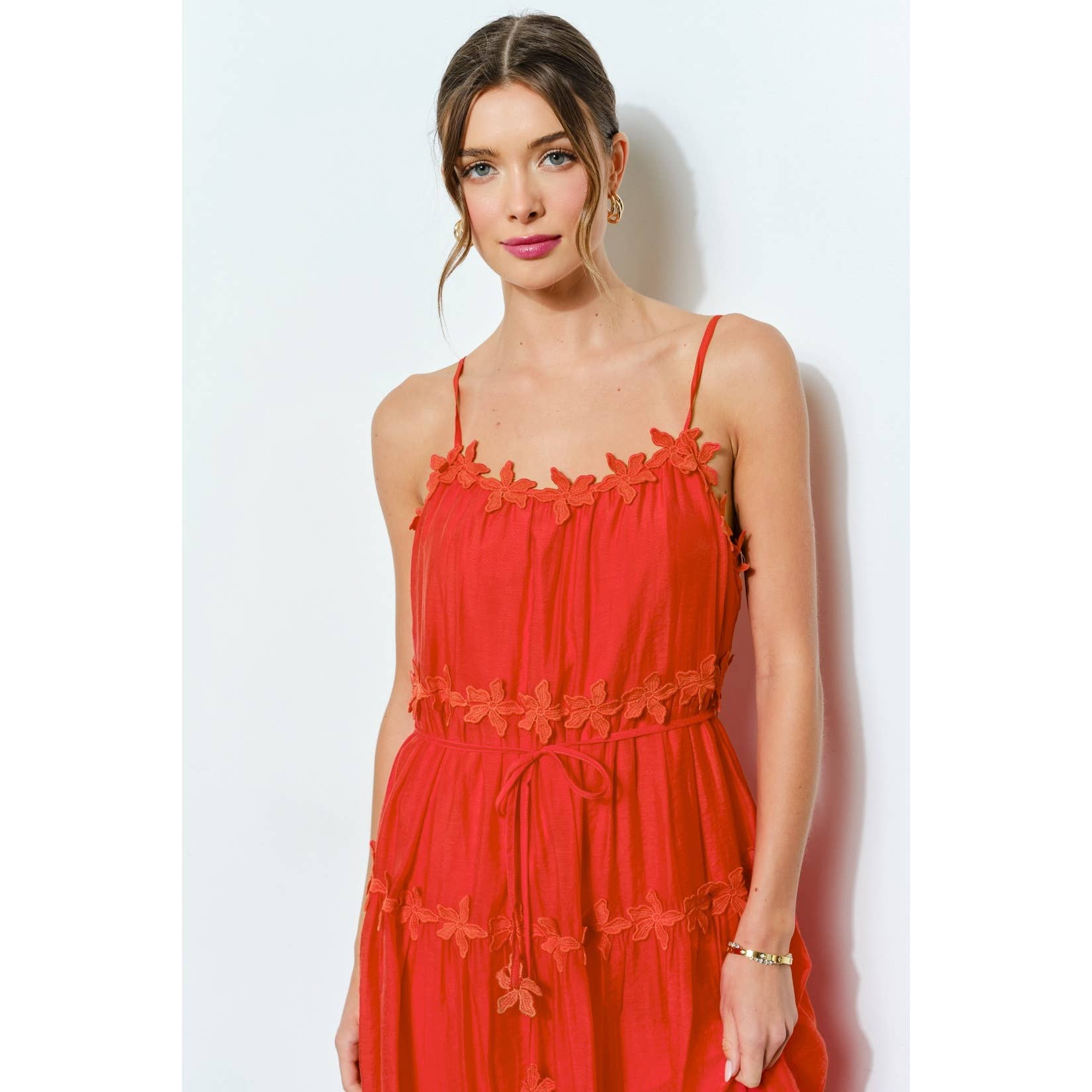 Woman wearing a red dress against a white background