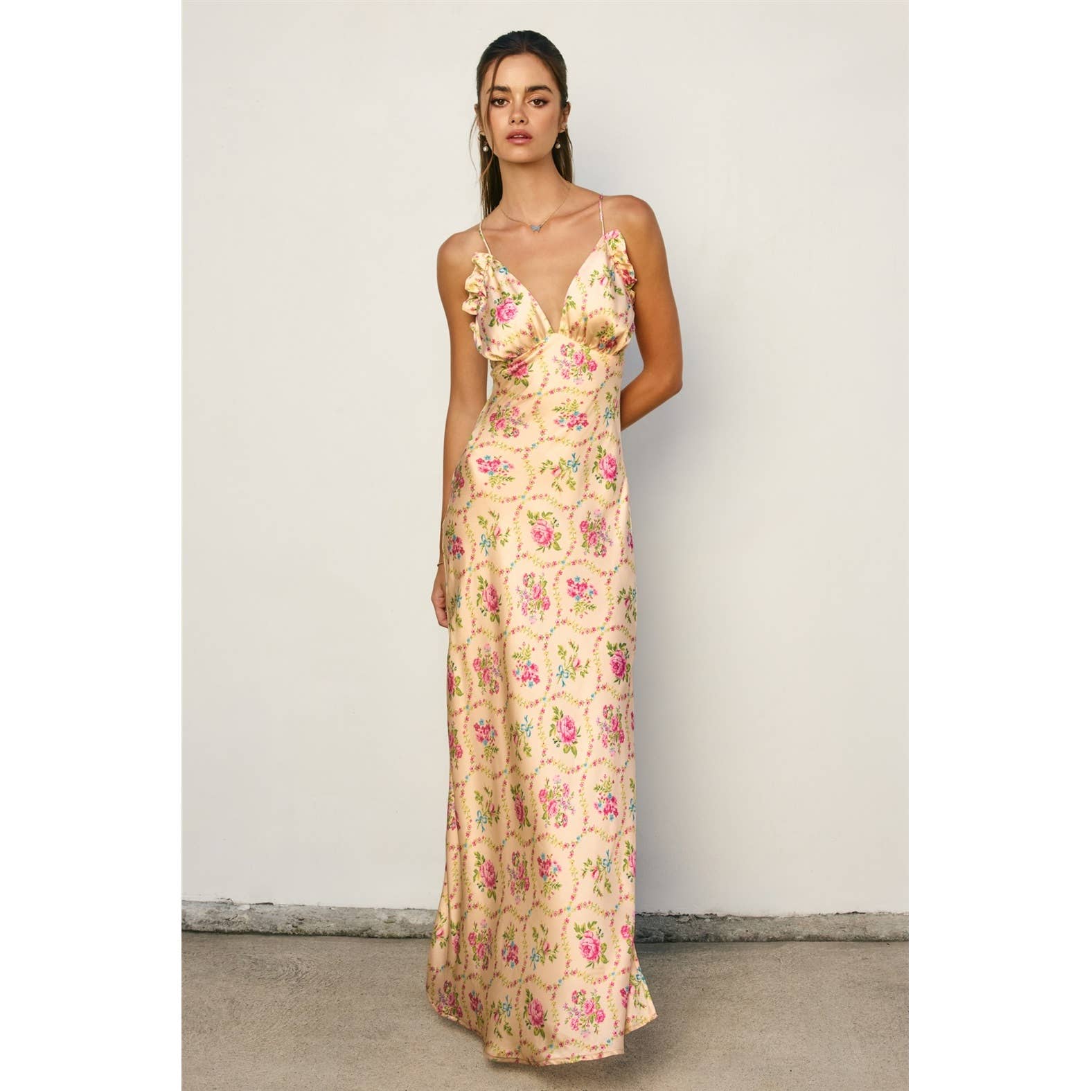 Woman wearing Eternal Afternoon Ruffled Triangle Bust Maxi Dress with floral print and delicate ruffle details on bust and straps
