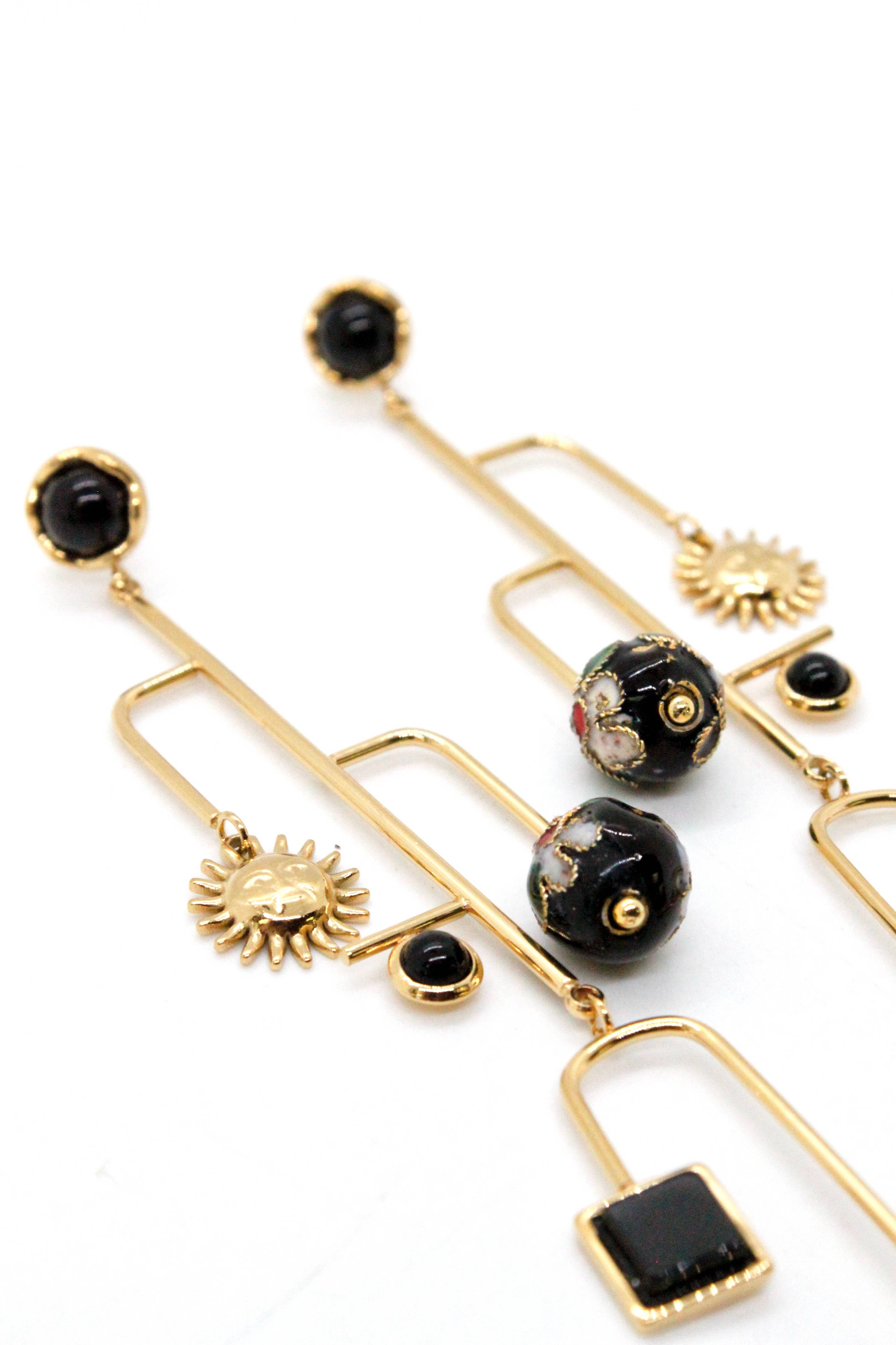 Museum Style Sun and Pepper Mobile Earrings with gold tones and black artisan bead accents in an elegant statement design