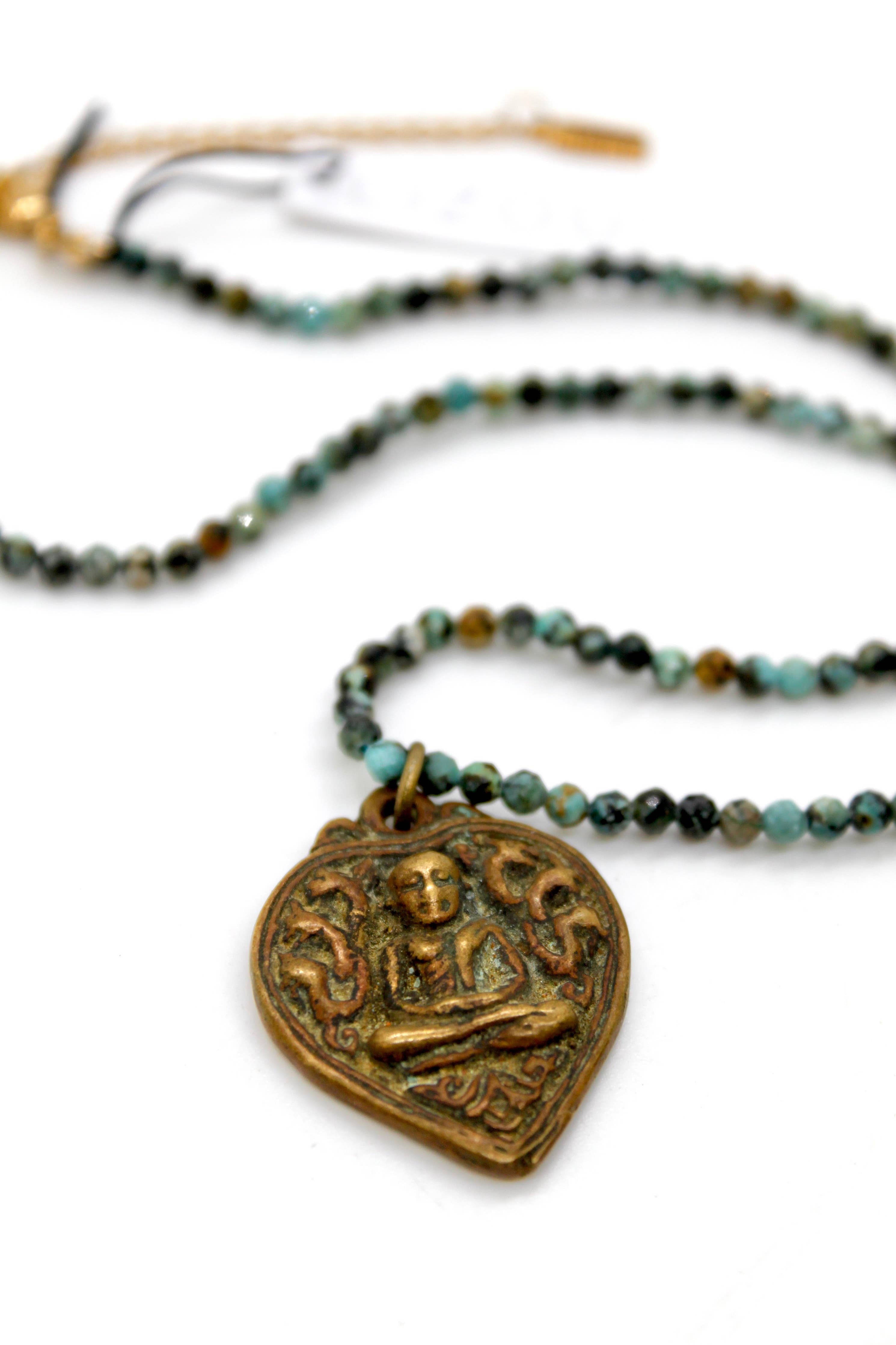 Buddha Necklace 117 - Faceted African Turquoise Necklace with brass Buddha pendant and multi-colored beads on white background
