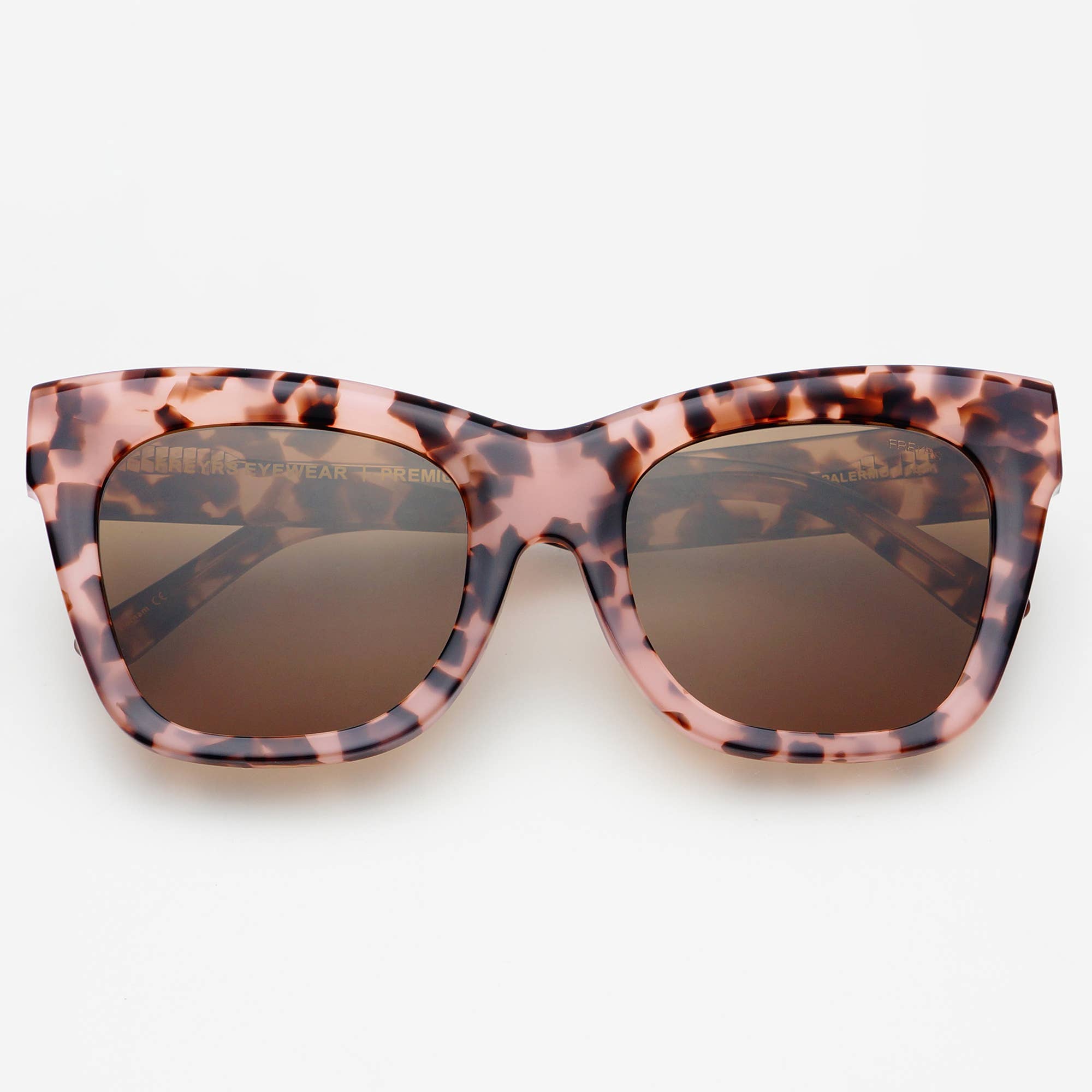 The Palermo Acetate Oversized Cat Eye Sunglasses by FREYRS Eyewear feature handmade pink and brown tortoiseshell frames and premium nylon lenses with 100% UVA/UVB protection, shown against a white background.