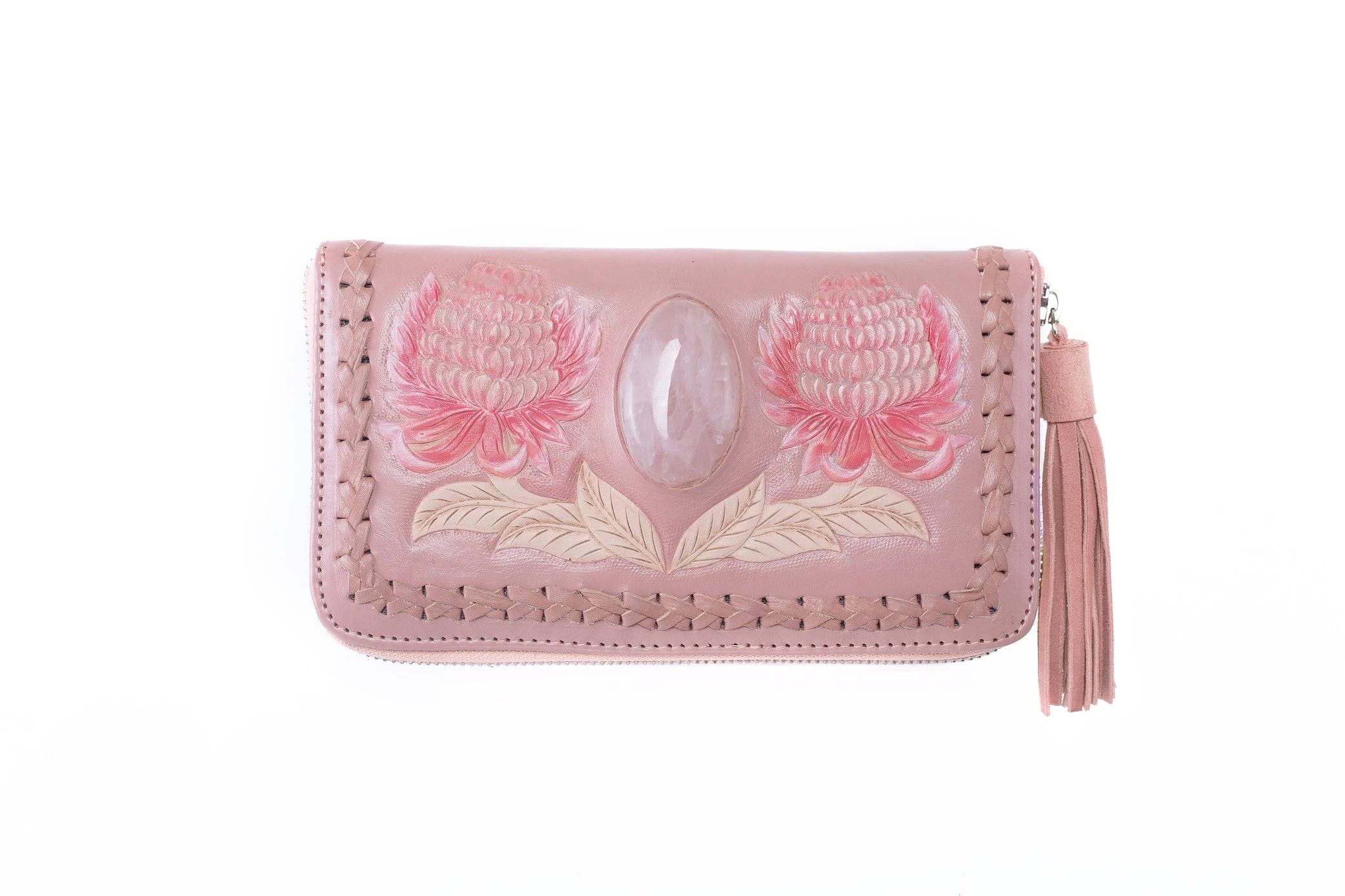 The Jodi Lee Wild Waratah Wallet Pink is a leather wallet with a tassel zipper, hand-tooled and painted with two pink flowers, and features a large genuine Rose Quartz gemstone set at the center.