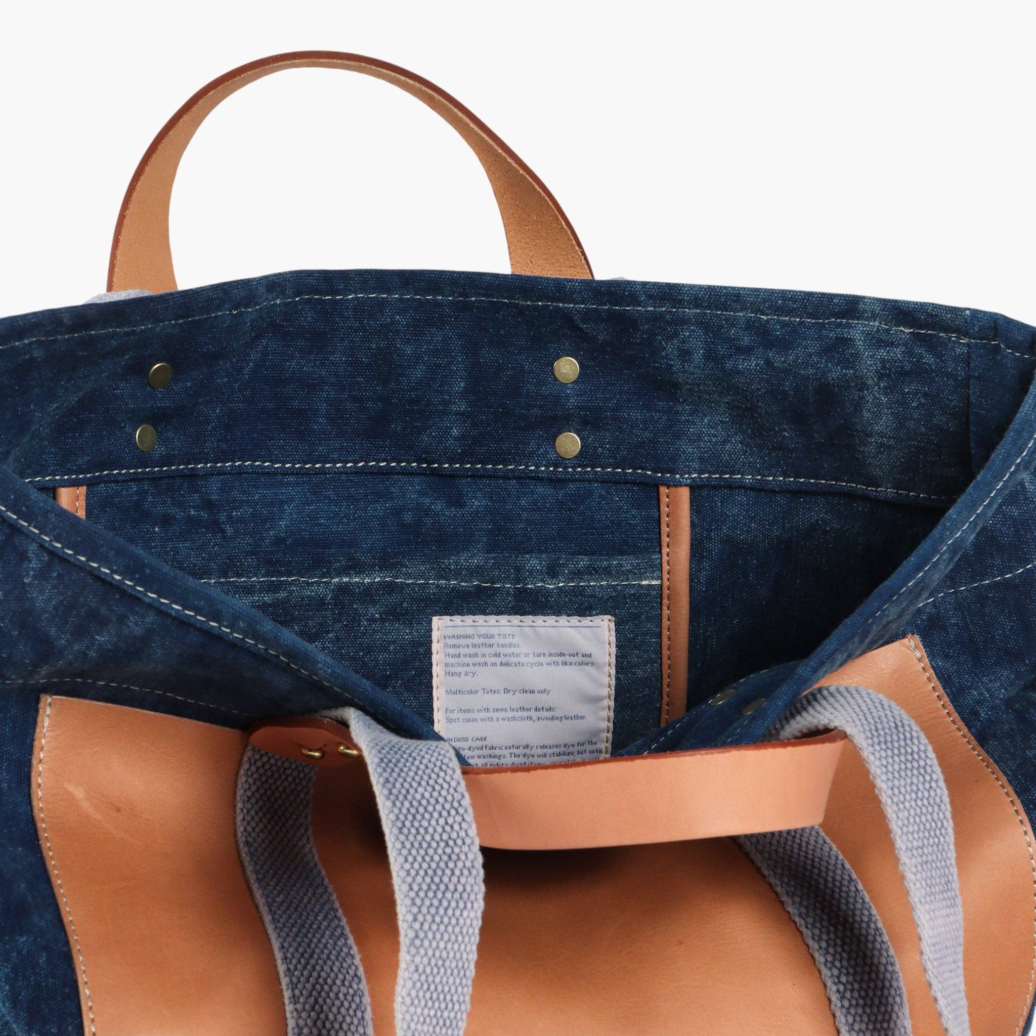 Editor Tote | Indigo + Tan with sturdy leather handles and durable indigo fabric interior lining details