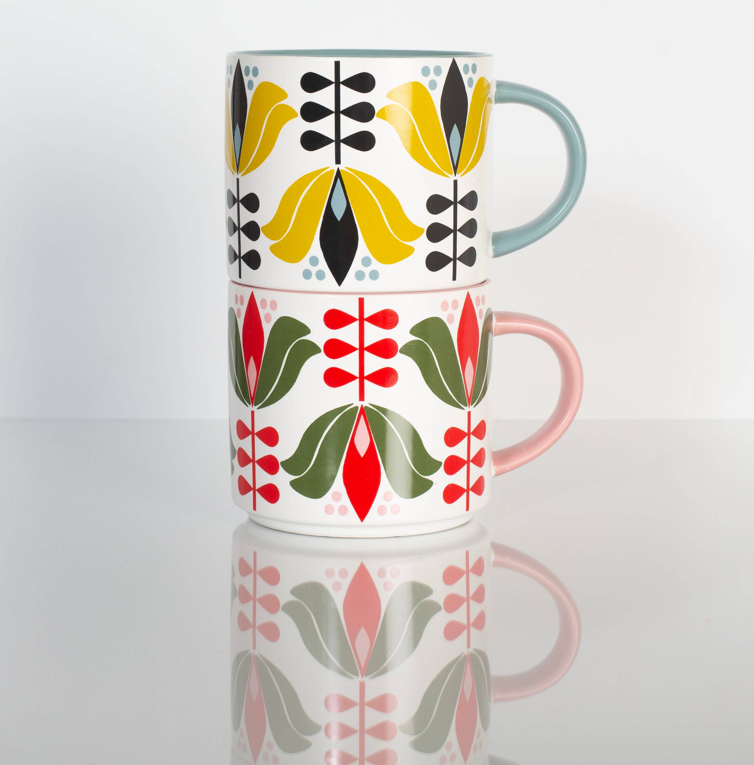 Yellow Lotus Flower Mid Century Stackable Matte Coffee Mug with floral design and pastel colored handles stacked on white surface