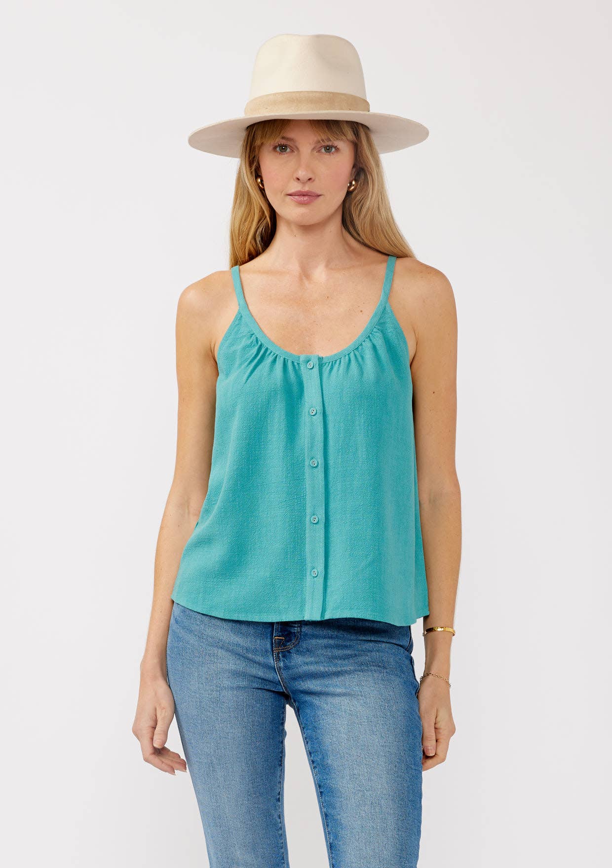 Woman wearing a teal Scoop Neck Button-Down Cami paired with jeans and a beige wide-brim hat