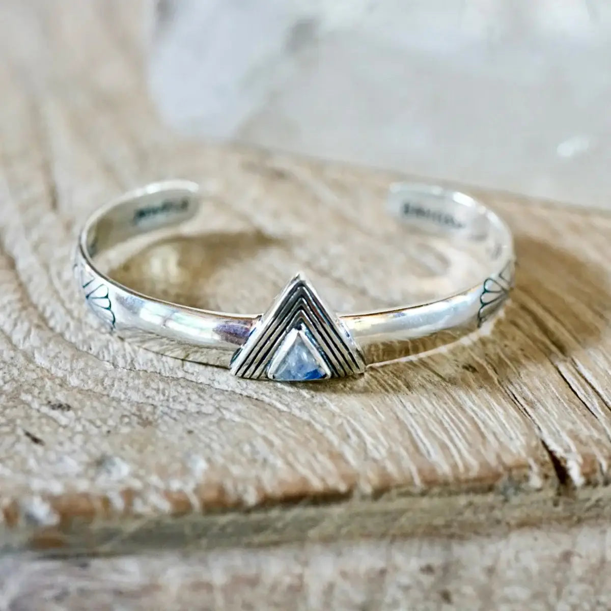 Hold Space Cuff featuring a geometric triangular design in polished silver with delicate engraved details.